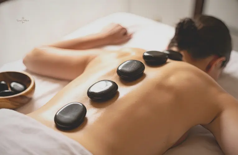 Hot stone massage benefits including deep muscle relaxation, stress reduction, improved blood circulation, and natural pain relief through heated stone therapy